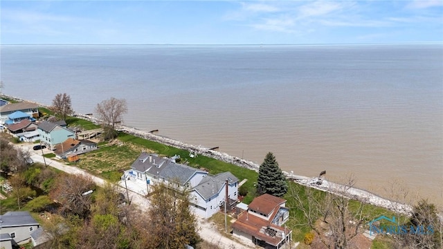 drone / aerial view featuring a residential view and a water view