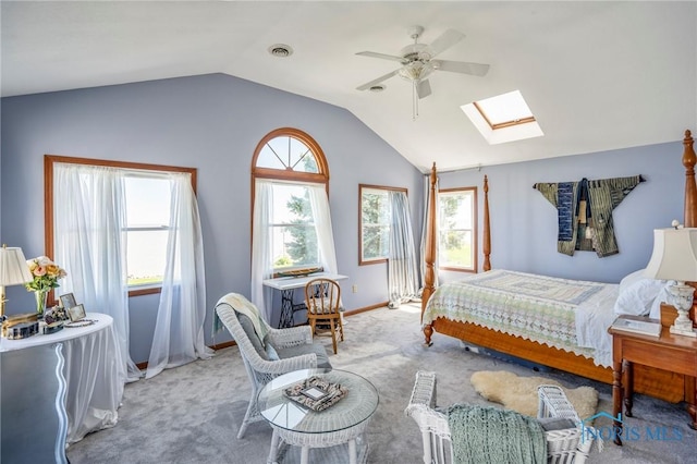bedroom with carpet, visible vents, baseboards, and vaulted ceiling with skylight