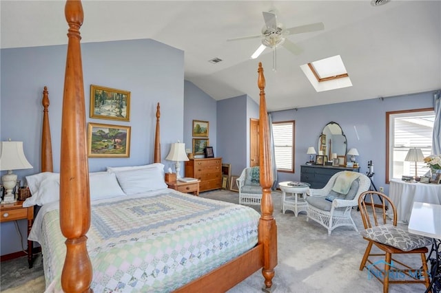 bedroom featuring visible vents, a ceiling fan, carpet flooring, and vaulted ceiling with skylight