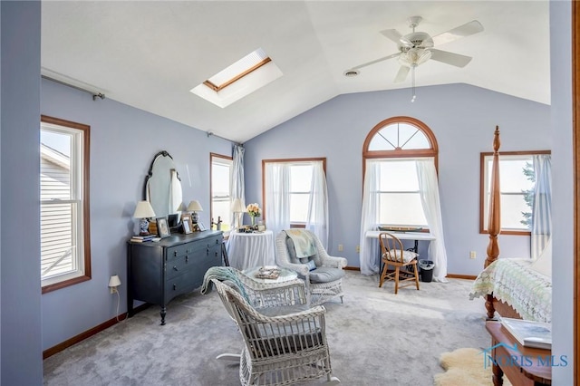 bedroom featuring baseboards, ceiling fan, lofted ceiling with skylight, and carpet