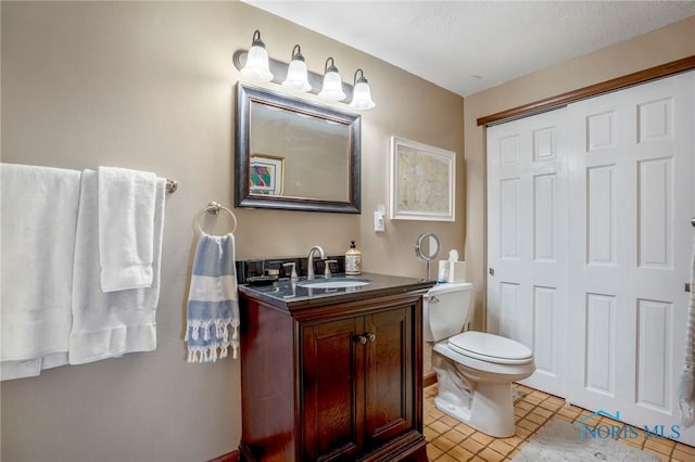 bathroom featuring toilet and vanity