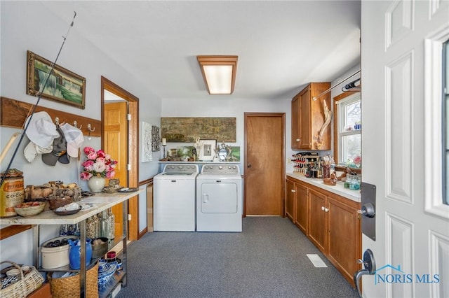 laundry room with carpet, laundry area, and washing machine and dryer