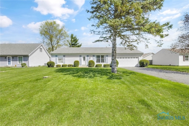 14384 Georgetown Dr, Bowling Green, OH 43402 - ranch-style house with driveway, a front lawn, and a garage