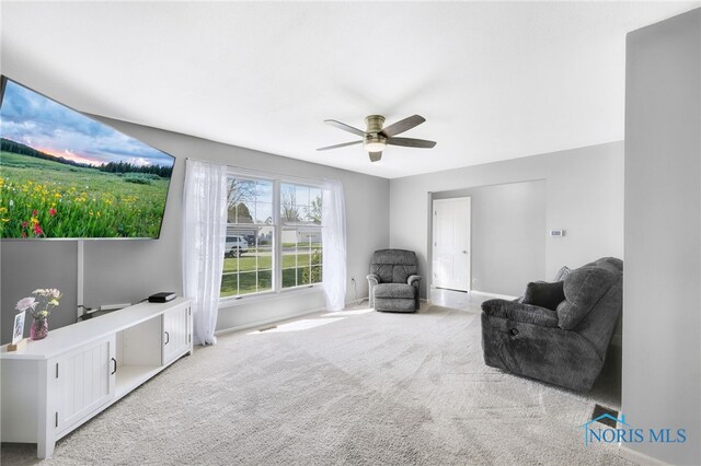 14384 Georgetown Dr, Bowling Green, OH 43402 - living area featuring baseboards, ceiling fan, and light colored carpet
