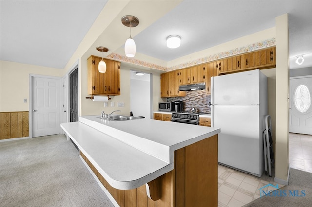 14384 Georgetown Dr, Bowling Green, OH 43402 - kitchen featuring range with gas stovetop, brown cabinets, a sink, under cabinet range hood, and freestanding refrigerator