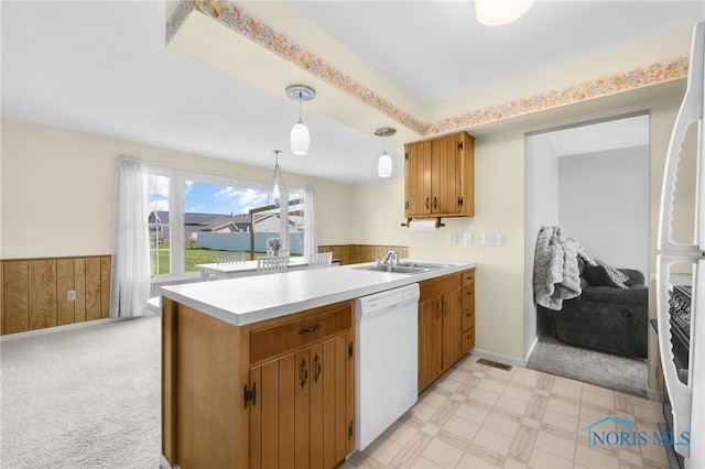 14384 Georgetown Dr, Bowling Green, OH 43402 - kitchen featuring a sink, white dishwasher, a peninsula, light countertops, and wainscoting