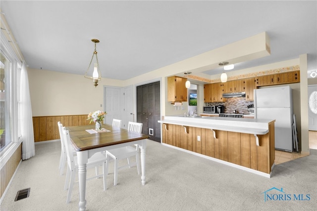14384 Georgetown Dr, Bowling Green, OH 43402 - kitchen with freestanding refrigerator, light countertops, brown cabinets, a sink, and visible vents