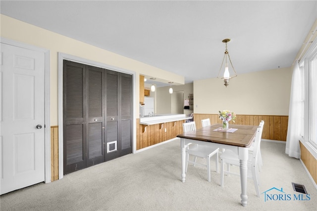 14384 Georgetown Dr, Bowling Green, OH 43402 - carpeted dining room featuring visible vents, wainscoting, and wooden walls