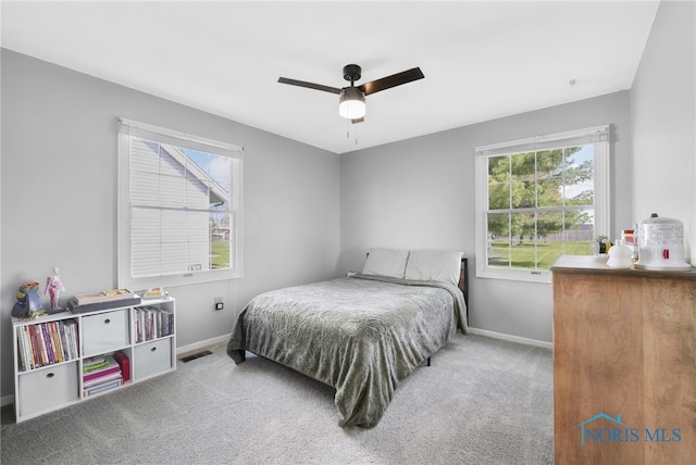 14384 Georgetown Dr, Bowling Green, OH 43402 - carpeted bedroom featuring visible vents, multiple windows, ceiling fan, and baseboards
