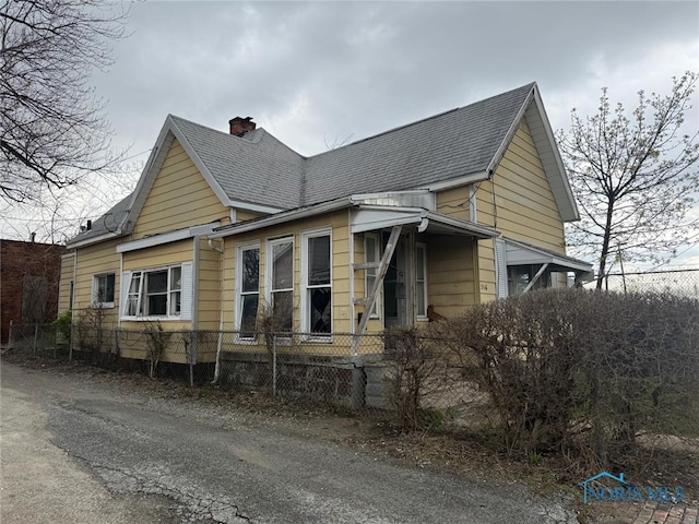 view of property exterior featuring a shingled roof, fence private yard, and a chimney