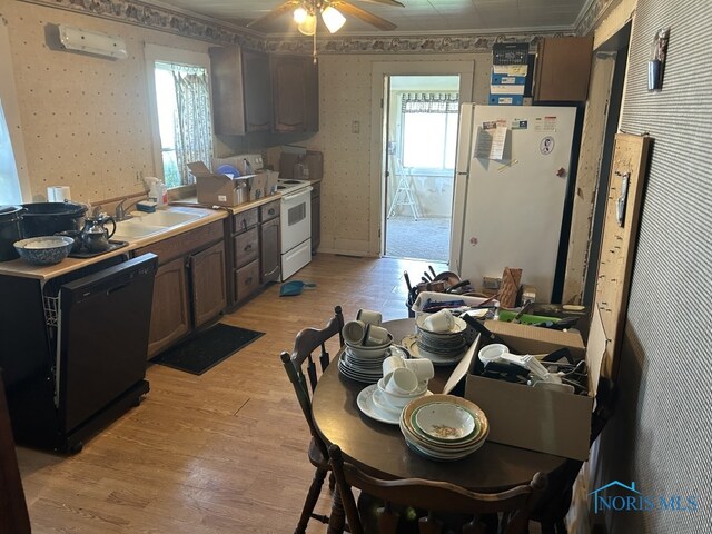kitchen featuring a ceiling fan, wallpapered walls, light wood-style flooring, and white appliances