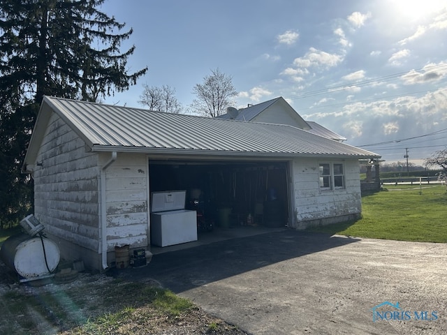 garage featuring concrete driveway