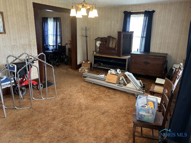 interior space featuring a notable chandelier and wallpapered walls