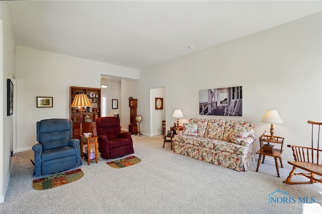 carpeted living room featuring baseboards