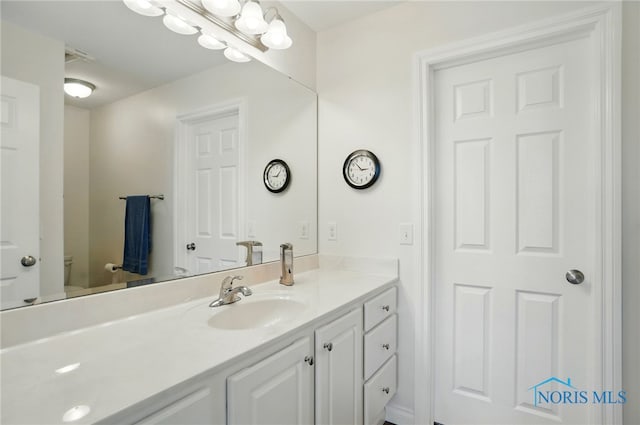 bathroom featuring toilet and vanity