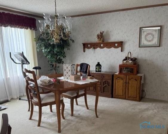 429 W Main St, Delta, OH 43515 - dining area with light colored carpet, crown molding, a textured ceiling, and a notable chandelier