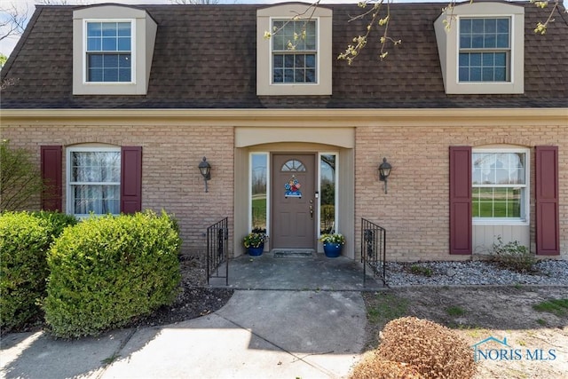 124 Miller Ave, Archbold, OH 43502 - property entrance featuring roof with shingles and brick siding