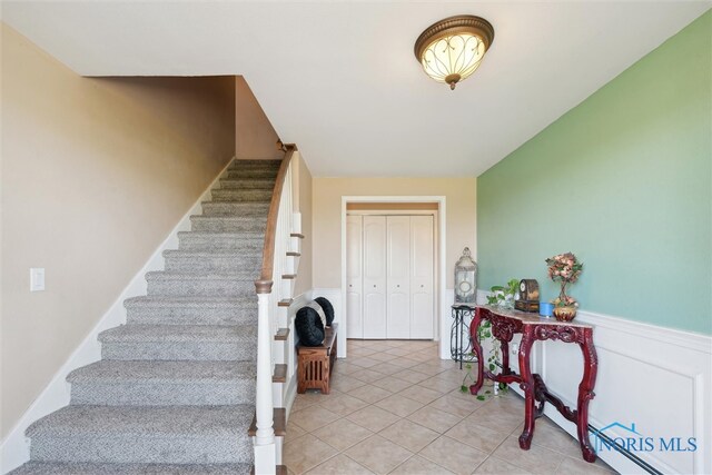 124 Miller Ave, Archbold, OH 43502 - staircase featuring tile patterned floors and a wainscoted wall