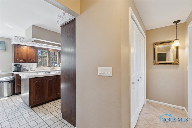 124 Miller Ave, Archbold, OH 43502 - kitchen featuring light countertops, hanging light fixtures, and baseboards