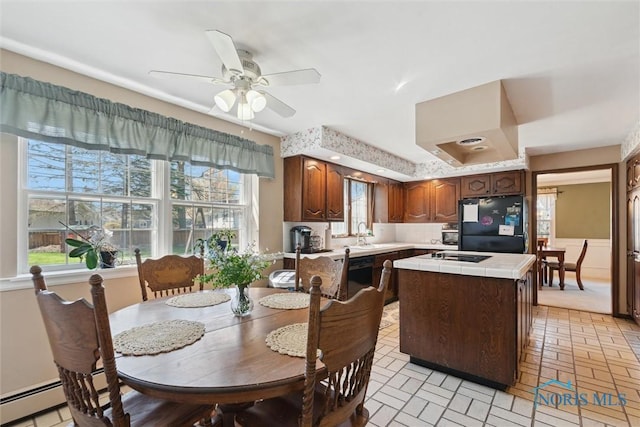 124 Miller Ave, Archbold, OH 43502 - kitchen with black appliances, tile countertops, a kitchen island, and plenty of natural light