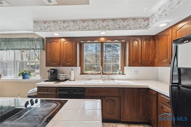 124 Miller Ave, Archbold, OH 43502 - kitchen with black appliances, tile countertops, a sink, and plenty of natural light