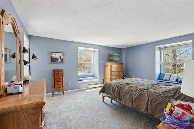 124 Miller Ave, Archbold, OH 43502 - carpeted bedroom featuring a baseboard heating unit, multiple windows, a textured ceiling, and baseboards