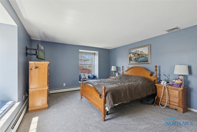 124 Miller Ave, Archbold, OH 43502 - bedroom featuring a baseboard heating unit, carpet floors, a textured ceiling, and baseboards