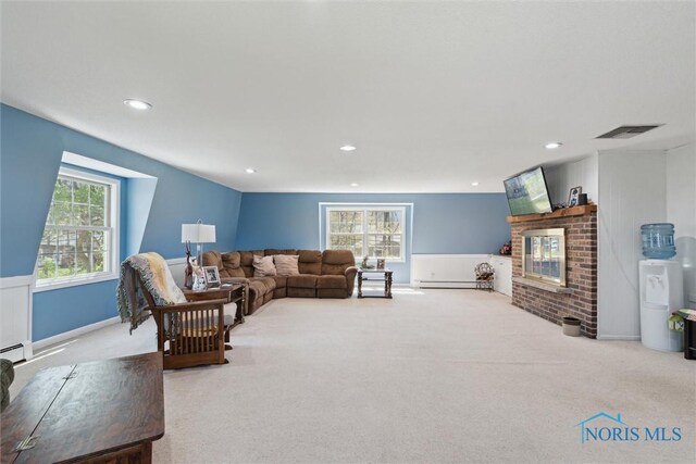 124 Miller Ave, Archbold, OH 43502 - carpeted living area with a fireplace, recessed lighting, and a baseboard radiator