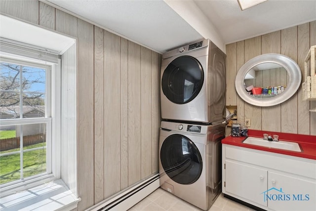 124 Miller Ave, Archbold, OH 43502 - laundry room with stacked washer / dryer, wood walls, cabinet space, and light tile patterned floors