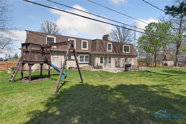 124 Miller Ave, Archbold, OH 43502 - rear view of house featuring a playground, mansard roof, roof with shingles, a patio area, and a chimney