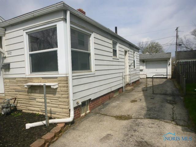 view of home's exterior featuring fence, driveway, crawl space, and a garage