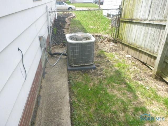 details featuring cooling unit and fence