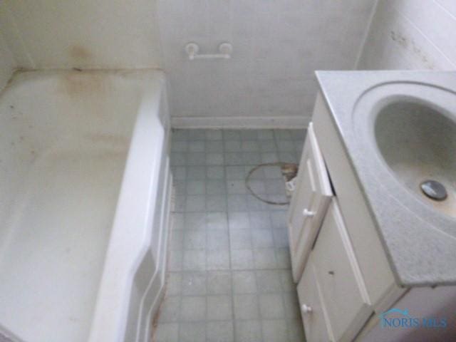 bathroom featuring tile patterned floors, baseboards, and vanity