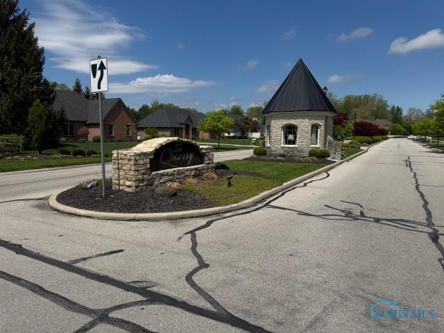 7704 Lonetree Ct, Maumee, OH 43537 - view of asphalt road with traffic signs, curbs, and a residential view