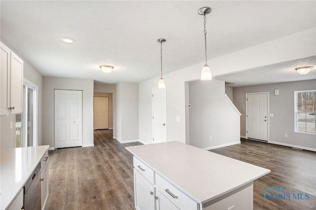 kitchen featuring light countertops, white cabinetry, baseboards, and dark wood-type flooring