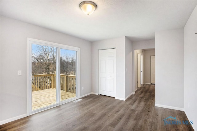 interior space featuring baseboards and wood finished floors