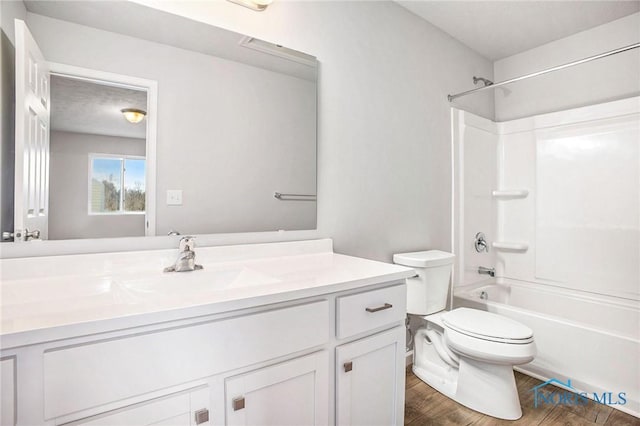 bathroom with vanity, shower / bath combination, toilet, and wood finished floors