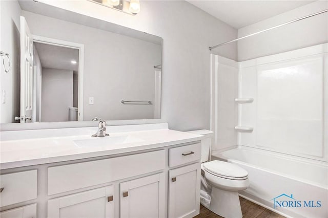 bathroom featuring shower / bath combination, vanity, toilet, and wood finished floors