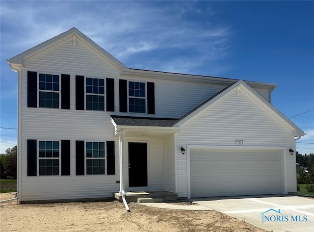 traditional home with an attached garage and driveway