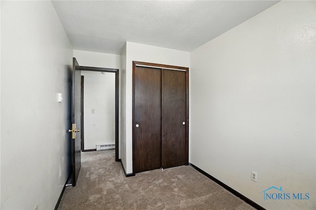13417 Center St, Weston, OH 43569 - unfurnished bedroom featuring baseboards, a baseboard heating unit, carpet floors, and a closet