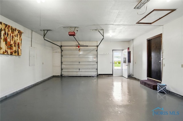 13417 Center St, Weston, OH 43569 - garage featuring electric panel, a garage door opener, and baseboards