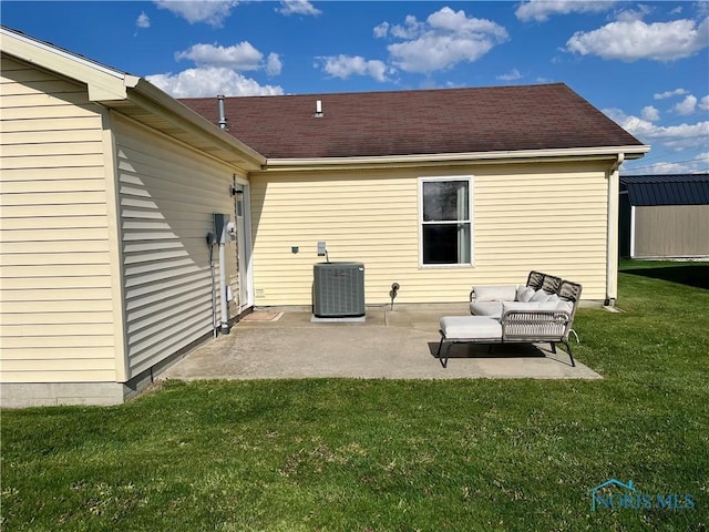 rear view of property featuring cooling unit, a storage unit, a patio area, outdoor lounge area, and a yard