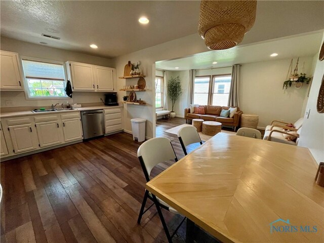 dining space featuring recessed lighting, a wealth of natural light, and dark wood-type flooring