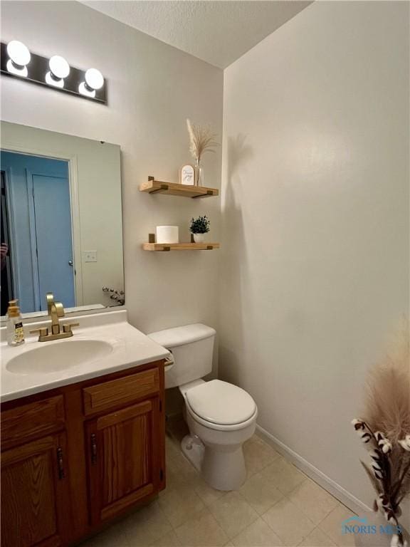 half bathroom with toilet, a textured ceiling, and vanity