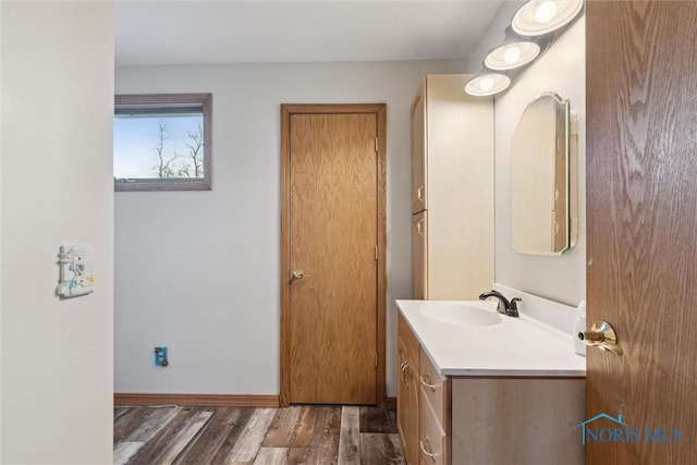 bathroom with wood finished floors and vanity