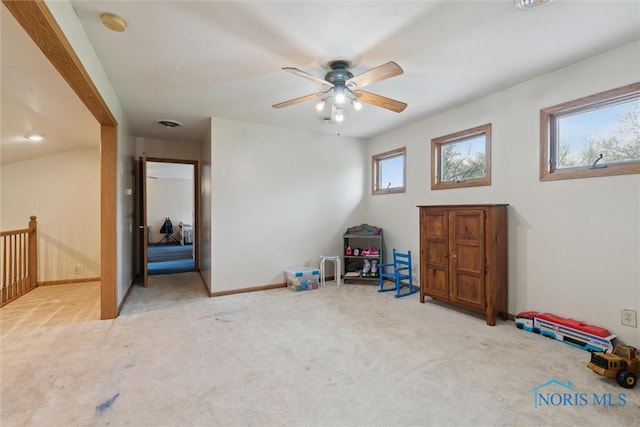 rec room featuring carpet flooring, ceiling fan, and baseboards