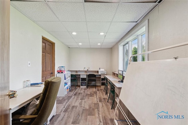office area featuring recessed lighting, a paneled ceiling, and wood finished floors