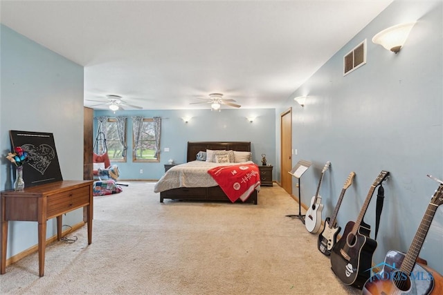 carpeted bedroom featuring ceiling fan and visible vents