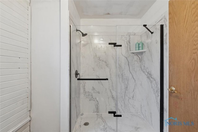 full bath featuring a marble finish shower