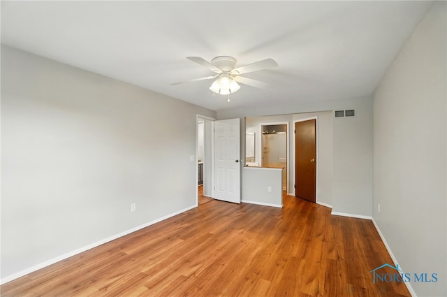 unfurnished bedroom featuring baseboards, visible vents, and light wood-type flooring